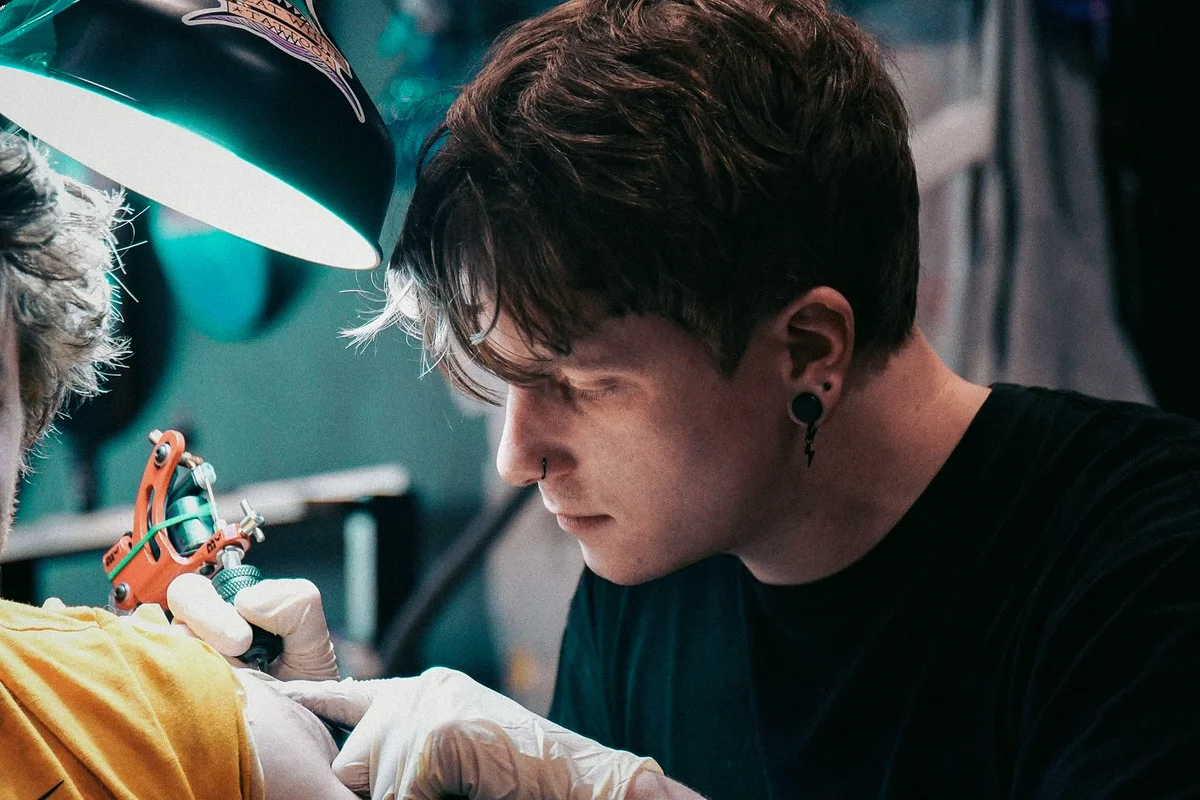 Brodie Bailey working on a tattoo, focused on the detail