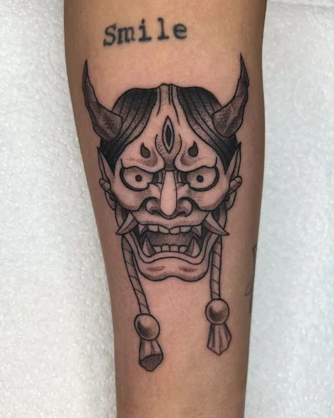 Horned Japanese-style mask tattoo in black and grey by Brodie Bailey